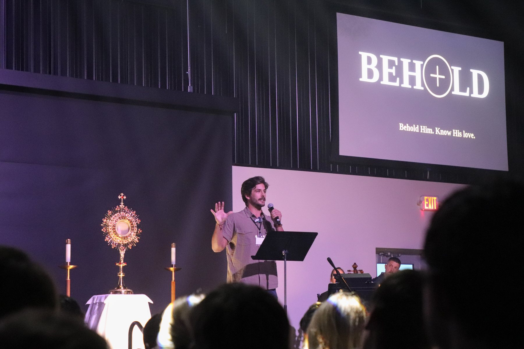 Danny Fisher speaking beside the Blessed Sacrament