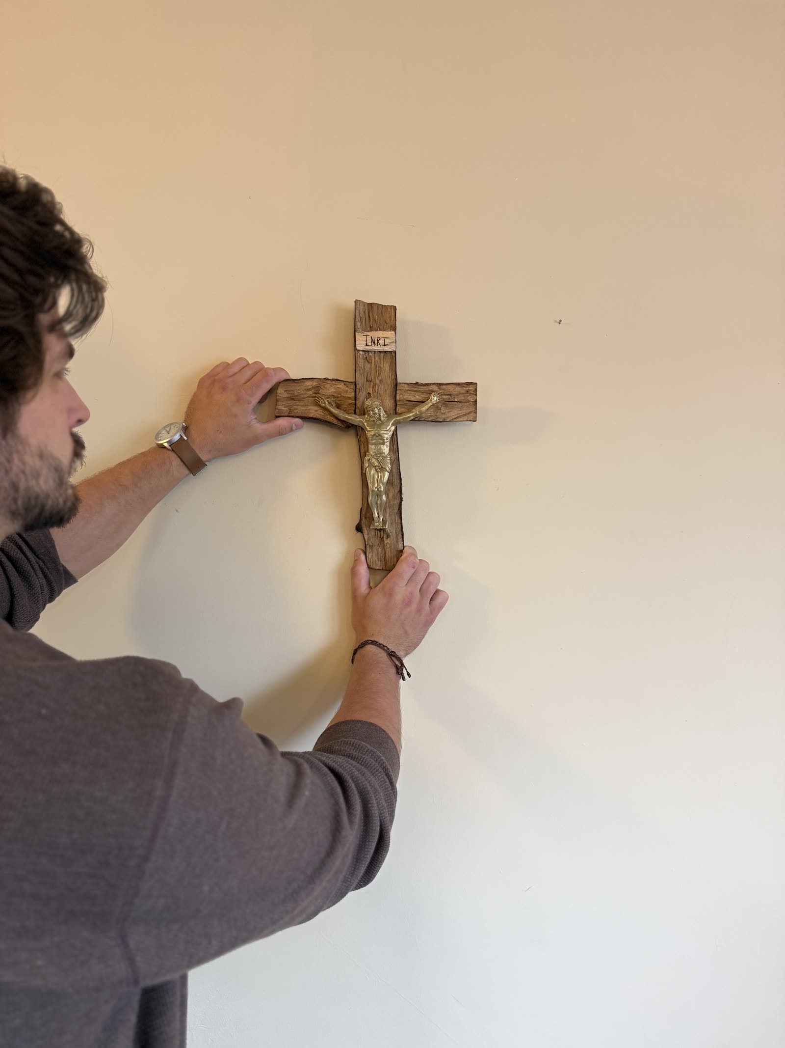 Danny Fisher hanging a handmade crucifix